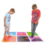 Two Boys stepping on multi colored square gel floor tiles