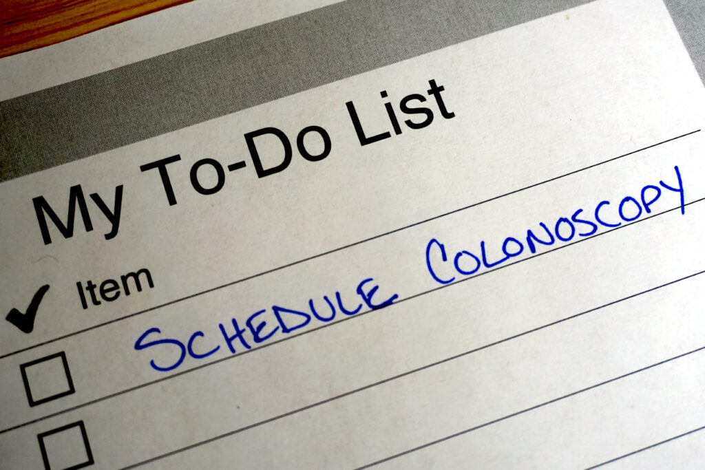 Photo shows "My To-Do List" with Schedule Colonoscopy listed on paper